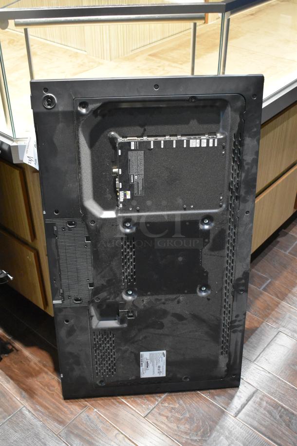 Back view of a Samsung ME46C 46" television showing ports, vents, and labels. Used condition. Buyer pickup required.