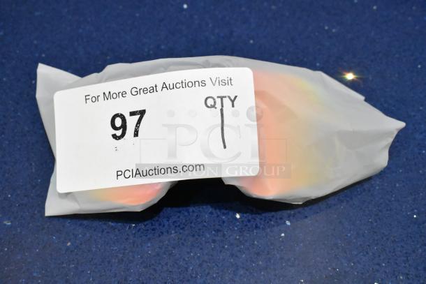 Brand new golden framed sunglasses with orange lens in packaging. Auction tag reads "97 QTY 1, PCIauctions.com".