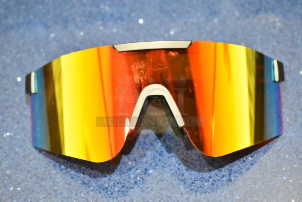 Brand new golden framed sunglasses with orange lens, featuring a sleek modern design, outstanding condition.
