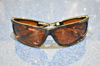 Brown framed sunglasses with BluBlocker orange lens, brand new. Sleek design, marked with BluBlocker logo.