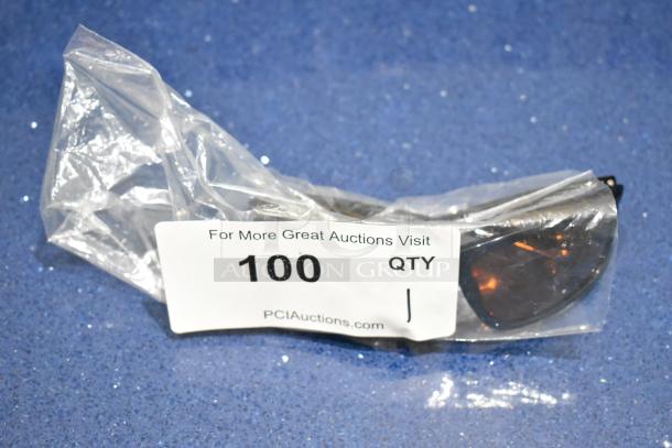 Brand new brown framed sunglasses with BluBlocker orange lens in plastic packaging. Quantity tag indicates 100.