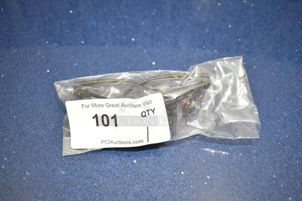 Brand new gray framed sunglasses with BluBlocker brown lenses, sealed in plastic packaging. Auction tag reads "101 QTY."