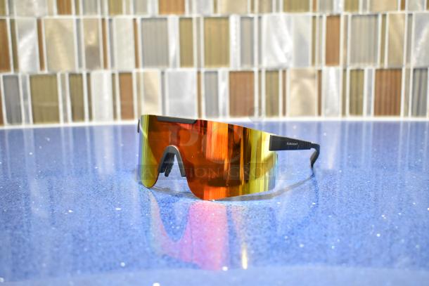 Brand new gray framed sunglasses with BluBlocker orange lens, sleek design, perfect condition, reflective finish.