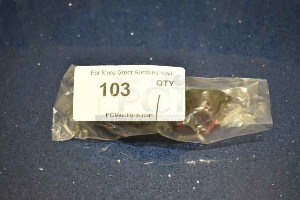 New brown framed BluBlocker sunglasses with brown lenses in packaging. Auction tag showing "103" and "PCIauctions.com."