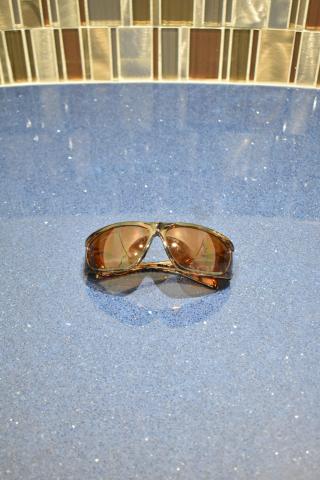 Brand new Viper sunglasses with brown frame and BluBlocker brown lenses, displayed on a reflective surface.