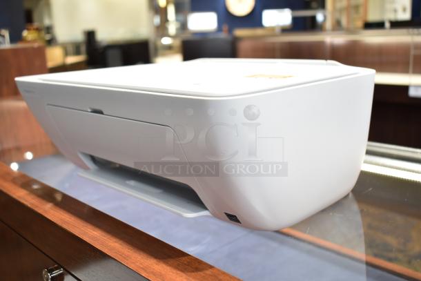 HP DeskJet 2755e printer with scanning and copying features, compact size, white finish, gently used condition.