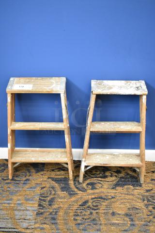 Two 2-foot wooden ladders, including a Werner W130-4, 200 lb capacity. Noticeable wear and paint marks.