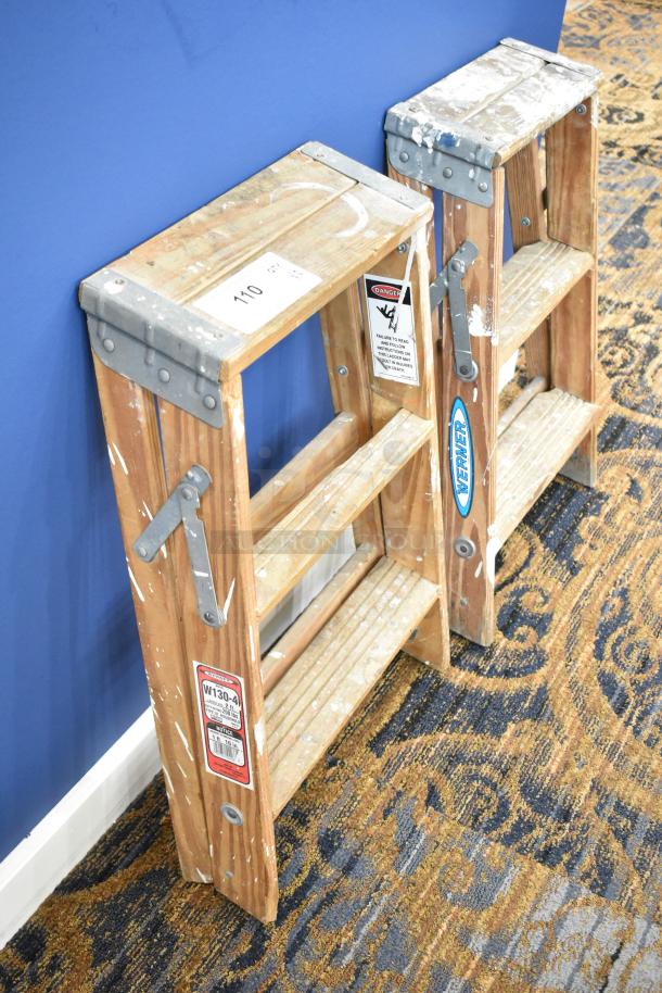 Two wooden 2' ladders, including a Werner W130-4 with 200 lb capacity. Visible wear; labels include warnings and model info.