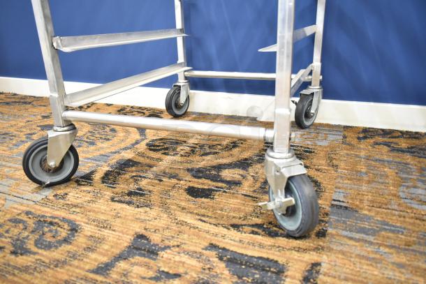 Commercial pan transport rack with durable metal frame on sturdy commercial casters, in good condition.
