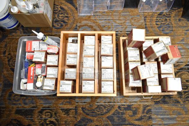 Assortment of 47 Wurth screw boxes and other hardware supplies in trays, featuring various sizes and labels, for auction.