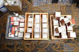 Assortment of 47 Wurth screw boxes and other hardware supplies in trays, featuring various sizes and labels, for auction.