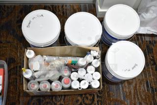 Assorted items including silicone tubes and Profi spray, plastic buckets, and labeled containers. Includes 30 items.