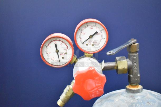 Acetylene tank with Sherwood valve. Red pressure gauges indicating PSI and welding capacity. Buyer must pick up.