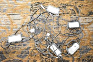 Husky String Lights with multiple enclosed light fixtures, tangled cables, and visible labels. Suitable for outdoor use.