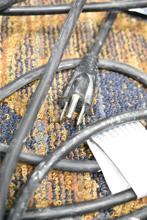 Husky String Lights with black cord and standard plug. Visible tag displays safety and usage instructions. Good condition.