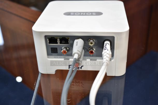 Sonos Box with two Ethernet ports, digital and analog audio ports, in excellent condition, tagged with "SONOS".