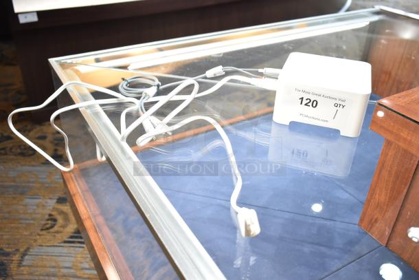 Sonos box and cables displayed on a glass table. Tag reads "120 QTY" from PCIAuctions.com.