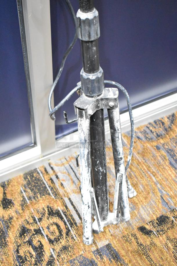 Metal 2 Head Work Light Tripod in used condition, with visible wear. Adjustable legs, suitable for dual lights.
