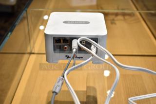 Sonos Connect streaming device with multiple ports, visible wires, and "Showroom" label; used for stereo updates.