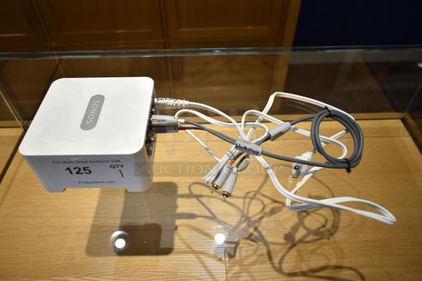 Sonos Connect streaming device with cables, model shown in good condition on a wooden surface with auction label "125".