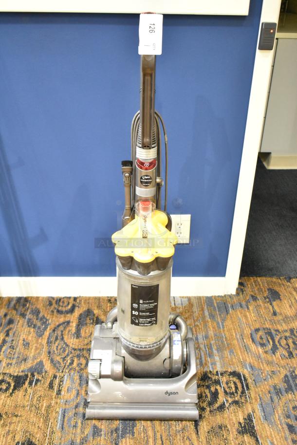 Dyson DC33 Vacuum Cleaner, 115 volts, 1 phase. Multi-floor use, visible wear, includes attachments, tag 126 present.