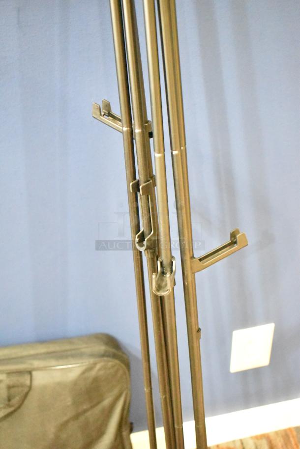 Three metal frames with adjustable hooks and a black carrying bag, all items in good condition.