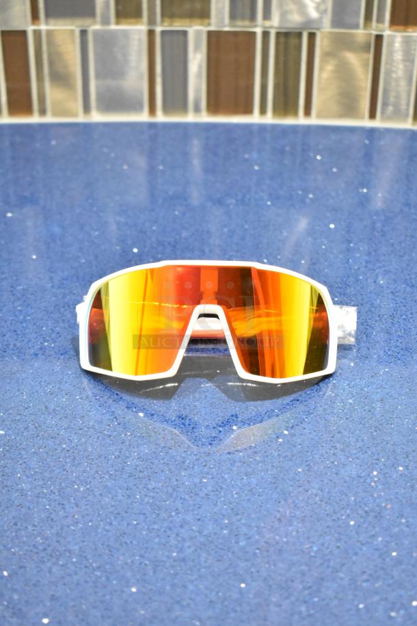 Brand new white framed sunglasses with BluBlocker orange lens. Sleek design, perfect condition.