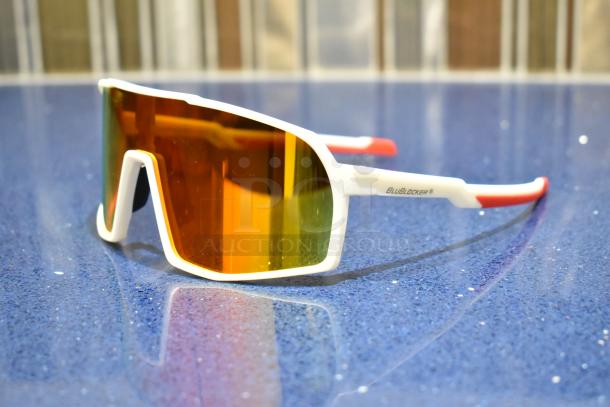 BRAND NEW white framed sunglasses with BluBlocker orange lens. Logo on arm; modern design.