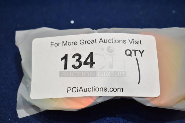 Brand new gray framed sunglasses with BluBlocker orange lens, wrapped in packaging labeled with auction details.