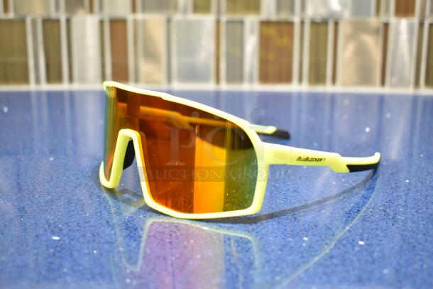 Brand new white-framed sunglasses with BluBlocker orange lenses. Features include sleek design and UV protection.