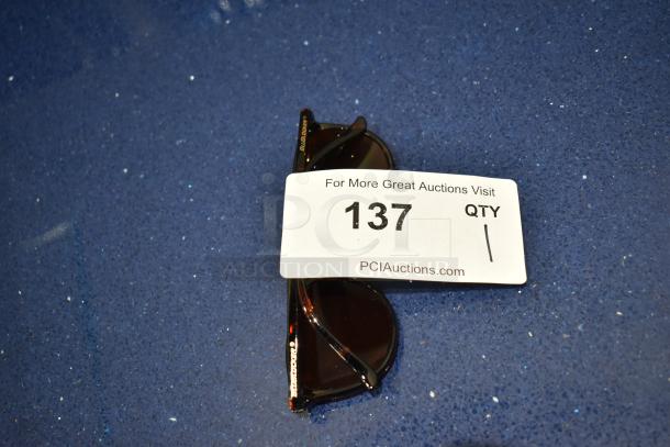 BRAND NEW! Tortoise shell framed sunglasses with BluBlocker brown lens. Auction lot 137 tag visible.