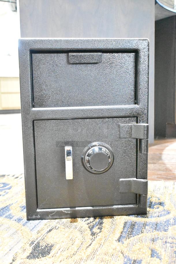 Black single compartment drop safe, sturdy build, no combination provided, features a dial lock, minor scuffs visible.