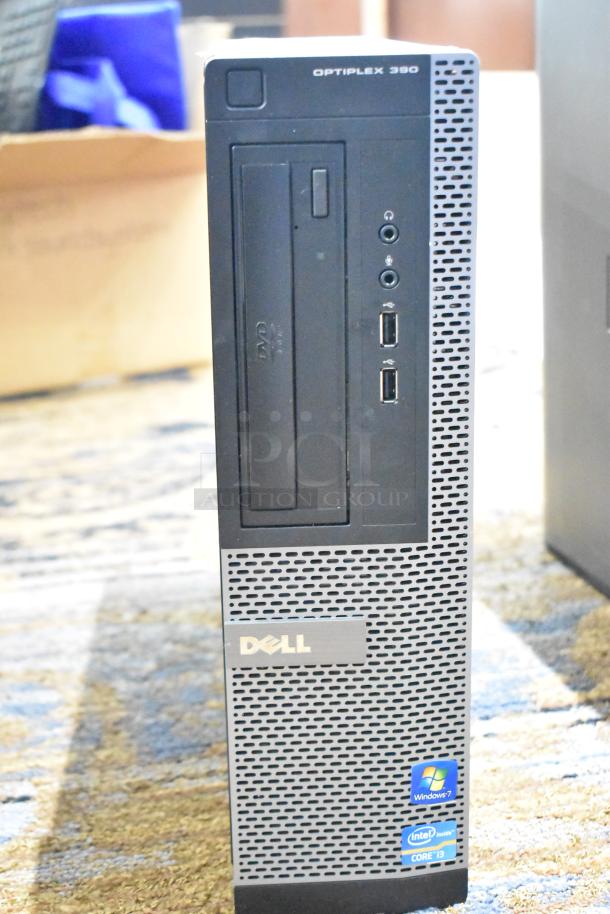 Dell Optiplex 390 computer tower, missing hard drive, front USB and audio ports, DVD drive, Windows 7 and Intel Core i3 labels.