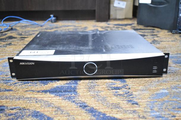 Hikvision DS-7716NXI-I4/16P/4S Network Video Recorder, no hard drive, rack unit, model markings visible, pre-owned condition.