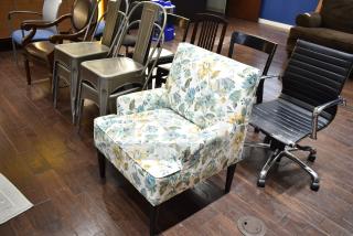 13 chairs, including gray Tolix-style dining chairs, a floral armchair, an office chair, and a wooden armchair.