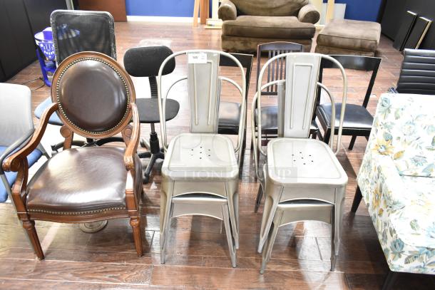 13 assorted chairs, including gray Tolix style dining chairs, floral armchair, office chair, wooden armchair.