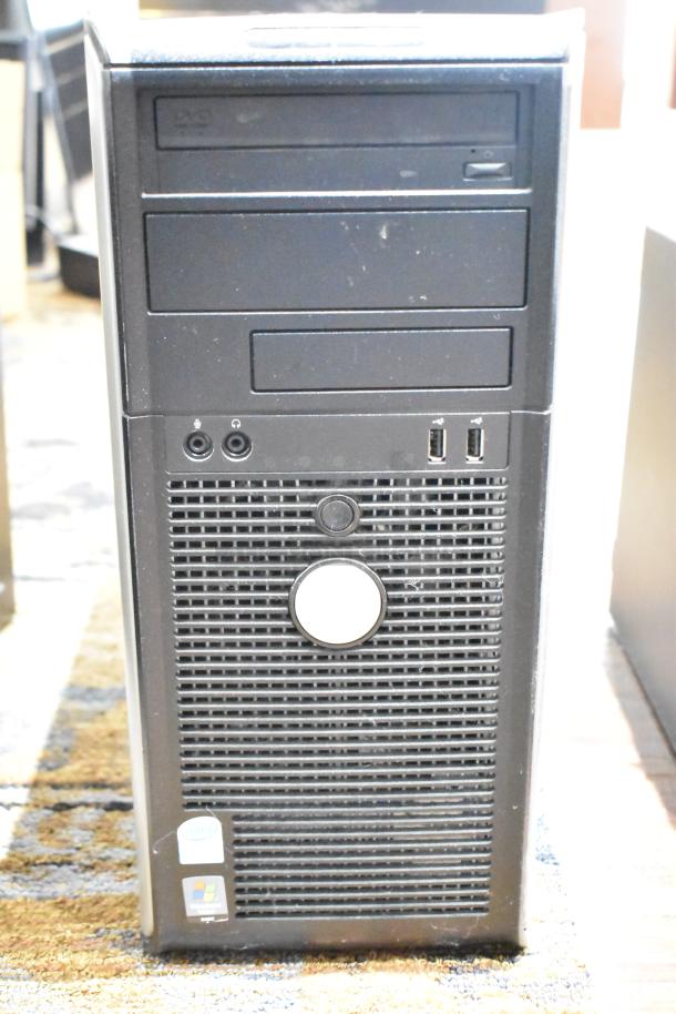 Dell Optiplex 360 computer tower, missing hard drive, visible DVD drive, two USB ports, Intel and Windows XP stickers.