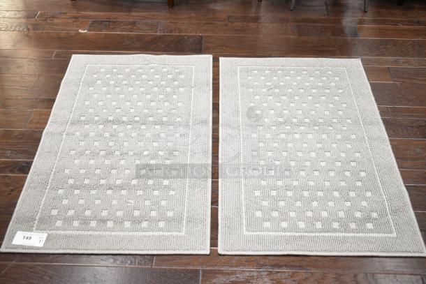 Two gray floor mats with a subtle square pattern, excellent condition, label indicating "149 qty 2X".