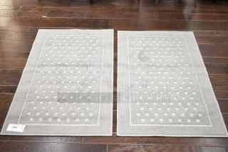 Two gray floor mats with a subtle square pattern, excellent condition, label indicating "149 qty 2X".