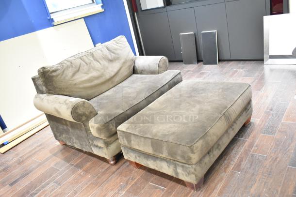 Gray armchair with matching ottoman, suede-like fabric, rolled arms, wooden legs, in used condition.