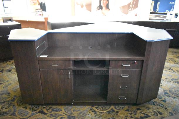 Wooden counter with five drawers and one door, dark finish, metal handles, good condition, spacious storage.