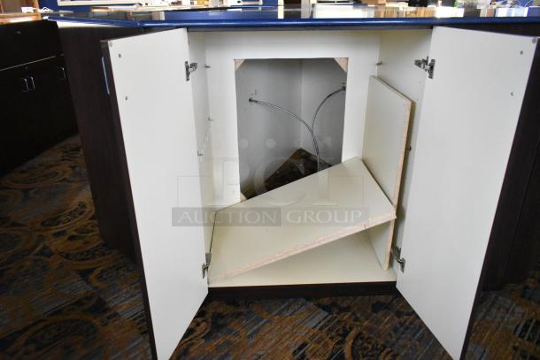 Wooden counter with five drawers and a door, featuring a laminate top. Currently, the inside is open with no shelves.