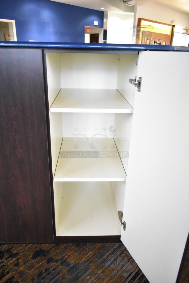 Wooden counter with 5 drawers and 1 door, interior shelves visible, dark wood finish, good condition.