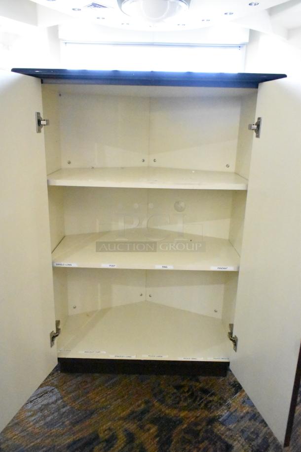 White wooden counter with open door, showcasing three shelves labeled for organization. Good condition.