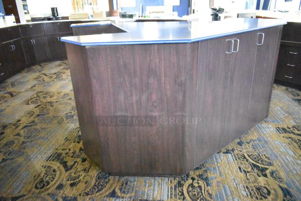Wooden counter with five drawers and one door, featuring a dark wood finish and metal handles, in good condition.