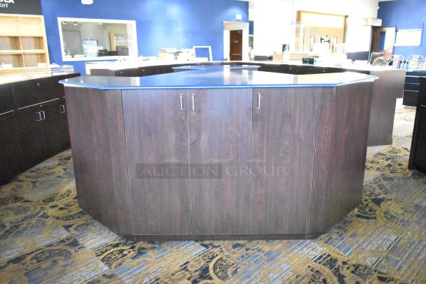 Wooden counter with 5 drawers and 1 door, dark wood finish, hexagonal shape. Ideal for office or retail use, well-maintained.