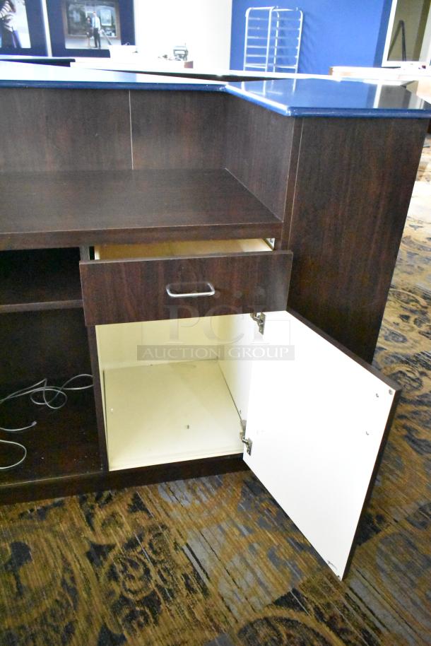 Wooden counter with five drawers and one door, dark finish, showing open drawer and door, good condition.