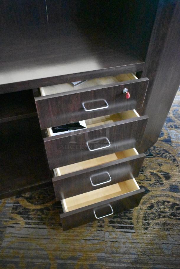 Wooden counter with 5 drawers and 1 door, dark finish, metal handles, good condition, visible keyhole on one drawer.