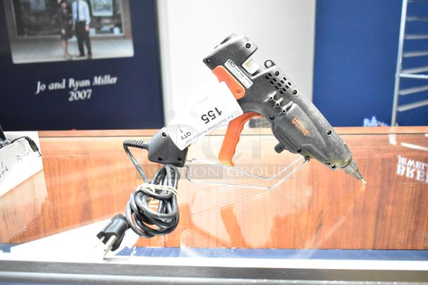 Uline H-1903 Heavy Duty Glue Gun, 120V, 1 Phase, shows wear, with attached power cord, auction tag visible.