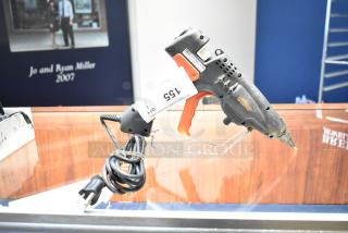 Uline H-1903 Heavy Duty Glue Gun, 120V, 1 Phase, shows wear, with attached power cord, auction tag visible.